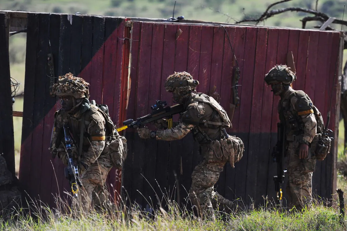 Soldiers take up position as they take part in a simulated military excercise of the British Army Training Unit in Kenya (BATUK) together with the Kenya Defence Forces (KDF) at the ol-Daiga ranch, high on Kenyas Laikipia plateau on March 27, 2018. 
Britain's 16 Air Assault Brigade was in Kenya with three companies of Gurkhas, a storied regiment made up predominately of Nepalese recruits, with their signature curved kukri knives. In recent years, infantry units were sent to Kenya for their final training before being deployed to Afghanistan and, for "rapid reaction force" 16 Air Assault, being always battle-ready is a point of pride. / AFP PHOTO / TONY KARUMBA        (Photo credit should read TONY KARUMBA/AFP via Getty Images)