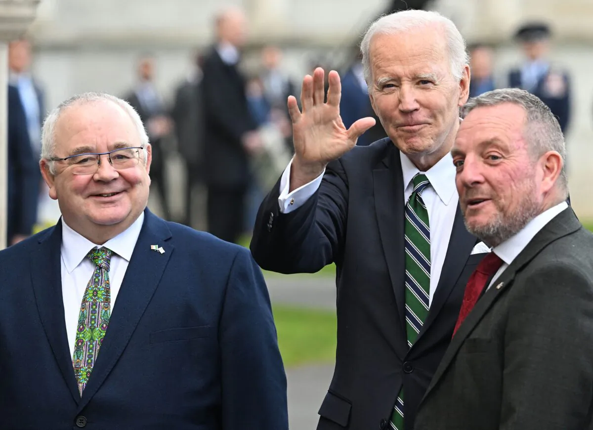 President Joe Biden (C) reacts as he poses with Ireland's Speaker of Dail Eireann, Sean O Fearghail (L) and Ireland's Speaker of the Seanad Eireann, Jerry Buttimer, after arriving at Leinster House the seat of the Irish parliament, in Dublin, on April 13, 2023. (JIM WATSON/AFP via Getty Images)