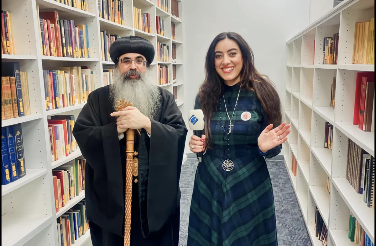 Mira Victor (R) with local Coptic Orthodox Priest (L) at a community event. (Courtesy of Mira Victor)
