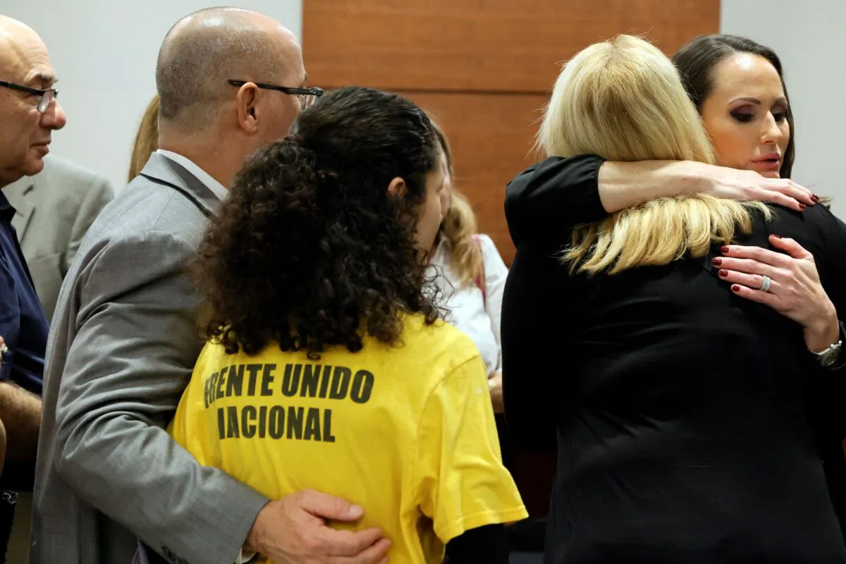 Judge Elizabeth Scherer hugs Jennifer Guttenberg following the sentencing hearing for Parkland school shooter Nikolas Cruz at the Broward County Courthouse in Fort Lauderdale, Fla., on Nov. 2, 2022. (Amy Beth Bennett/Pool/South Florida Sun Sentinel via AP)