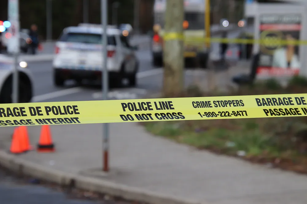 Police officers and paramedics attend the scene of a stabbing onboard a transit bus in Surrey, B.C. on April 1, 2023. (The Canadian Press/Shane MacKichan)