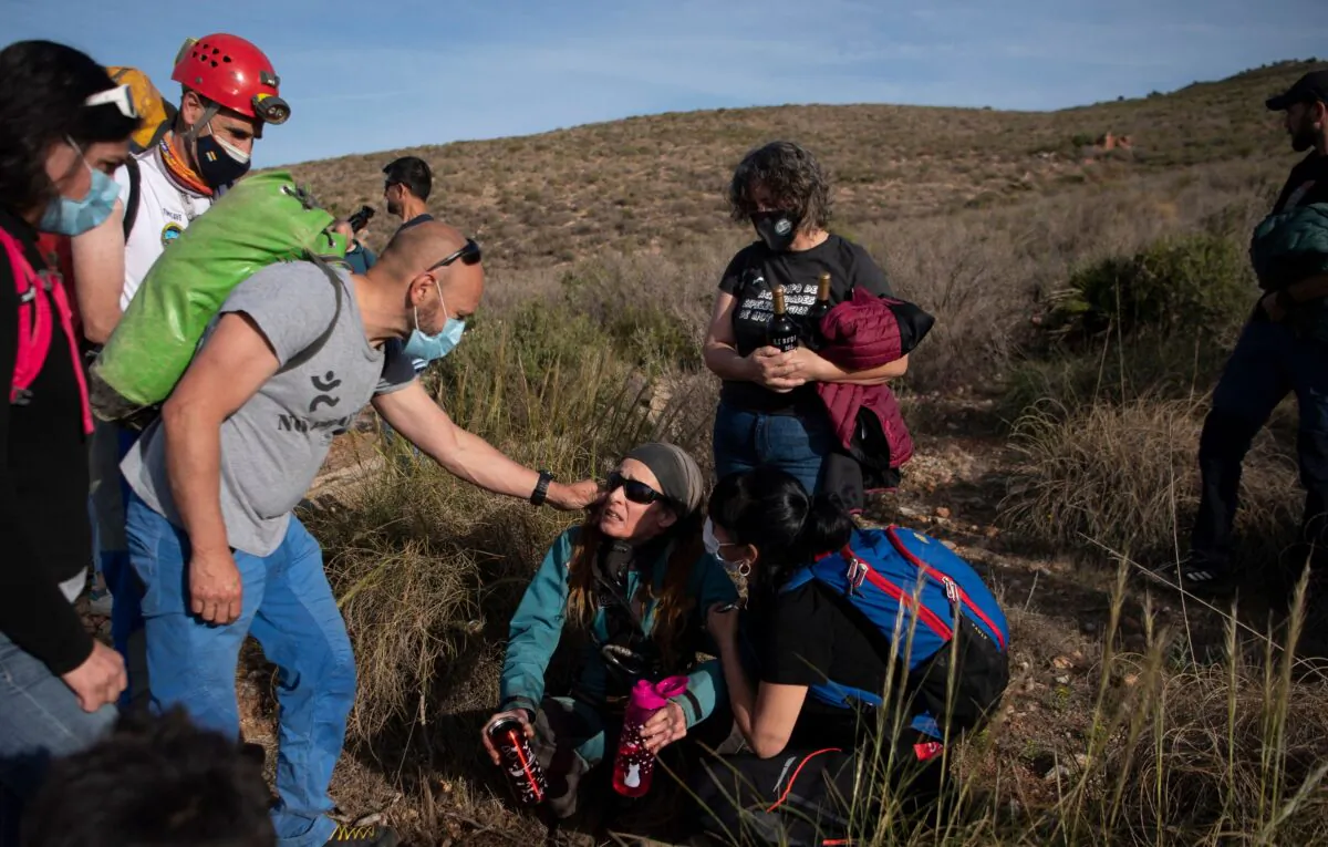 Spanish sportswoman Beatriz Flamini (C) is attended by relatives upon getting out of a cave in Los Gauchos, near Motril, Spain, on April 14, 2023. (Jorge Guerrero/AFP via Getty Images)
