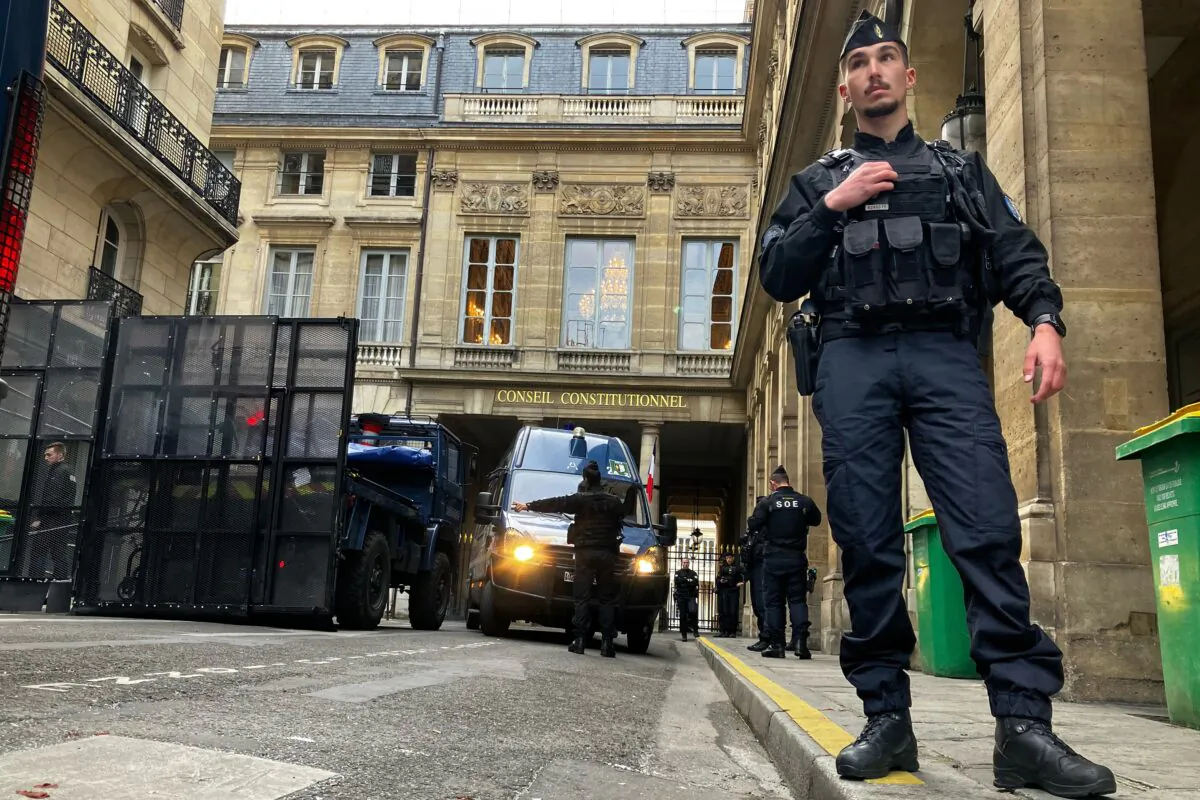 Police forces set up a barricade in front of the Constitutional Council in Paris on April 14, 2023. (Alexander Turnbull/AP Photo)