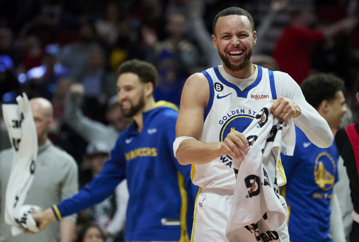 Golden State Warriors guard Stephen Curry (30) reacts after a basket by forward Jonathan Kuminga during the second half of an NBA basketball game in Portland, Ore., on April 9, 2023. (Craig Mitchelldyer/AP Photo)