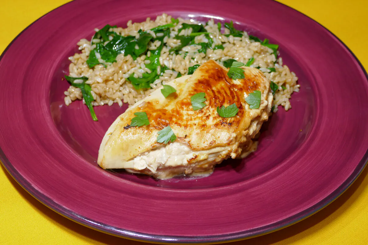 Caramelized Onion-Stuffed Chicken Breast with Spinach and Brown Rice. (Linda Gassenheimer/TNS)