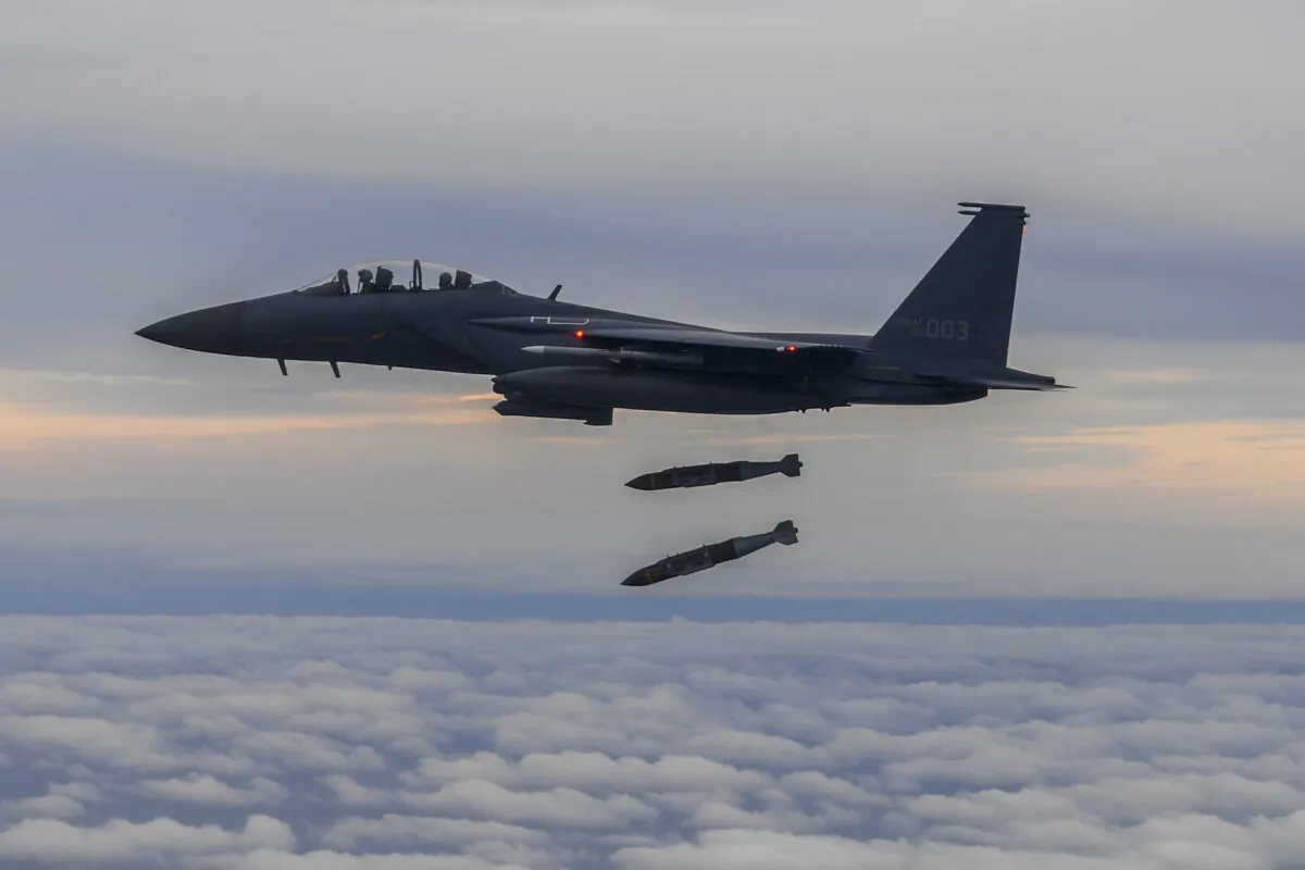 A South Korean F-15K fighter releases two Joint Direct Attack Munition (JADAM) bombs into an island target in response to North Korea's intermediate-range ballistic missile (IRBM) launch earlier in the day at an undisclosed location on Oct. 4, 2022. North Korea fired an intermediate-range ballistic missile (IRBM) over Japan in its first launch of an IRBM in eight months, according to South Korea’s military. (South Korean Defense Ministry via Getty Images)