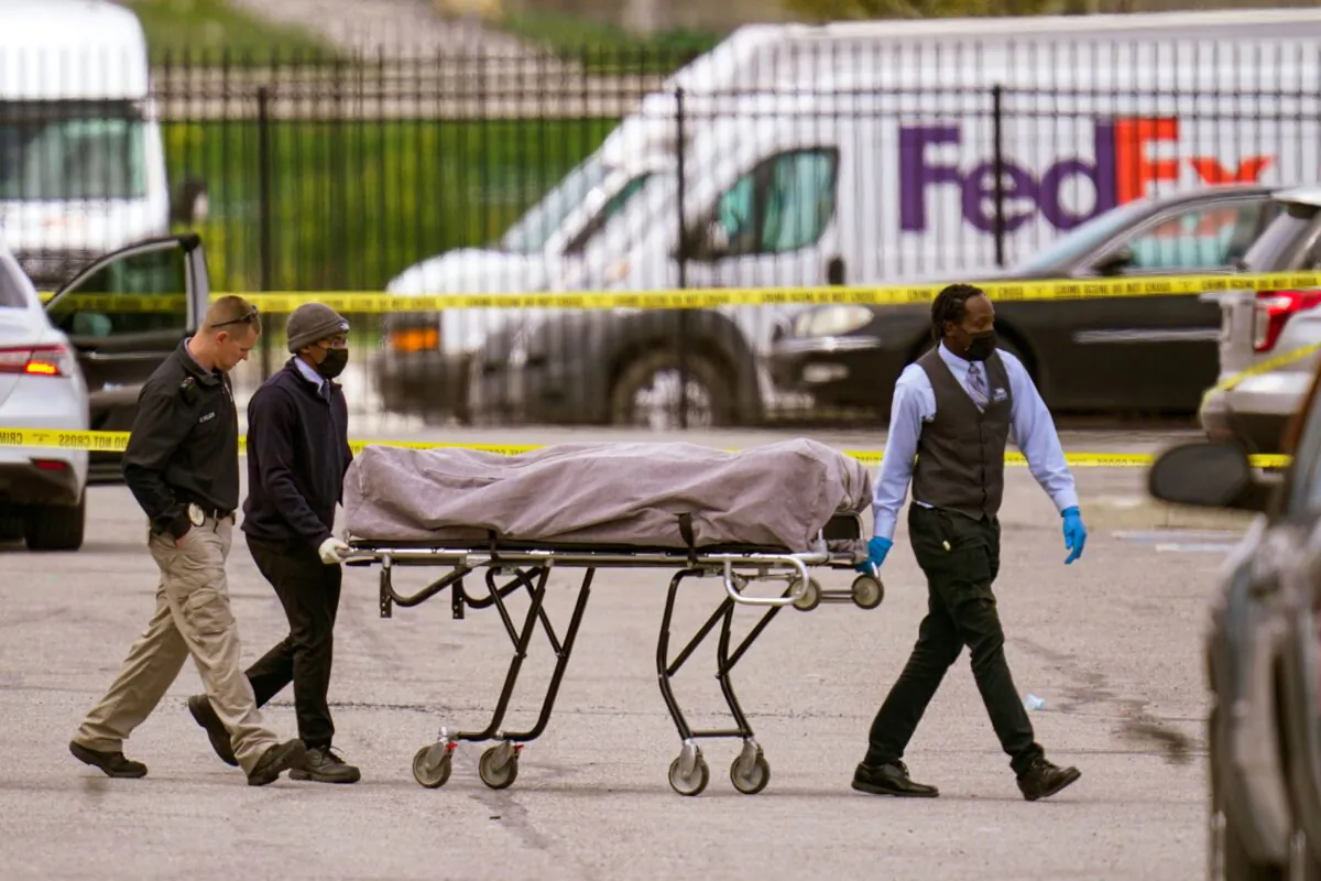 A body is taken from the scene where multiple people were shot at a FedEx Ground facility in Indianapolis, on April 16, 2021. (Michael Conroy/AP Photo)