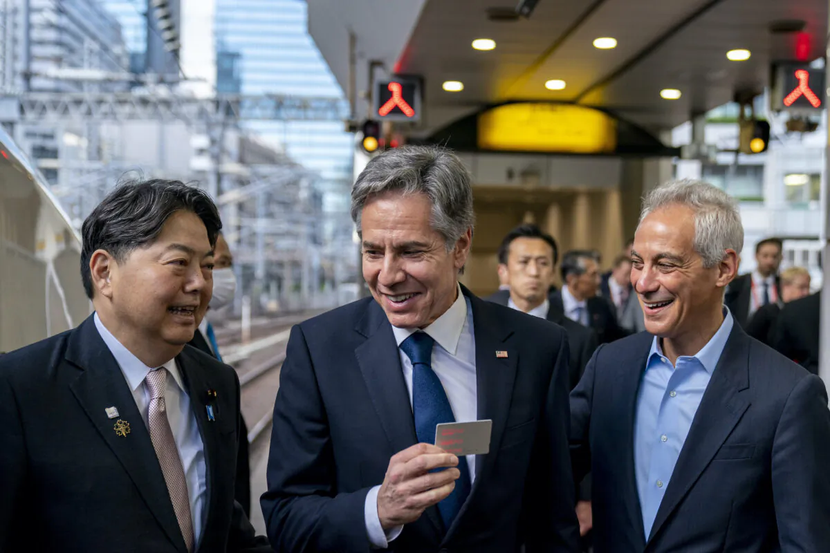 U.S. Secretary of State Antony Blinken (C), accompanied by U.S. Ambassador to Japan Rahm Emanuel (R), holds up his boarding card as he is greeted by Japanese Foreign Minister Yoshimasa Hayashi (L), as he boards a train at Tokyo Station to travel to Karuizawa for a G-7 Foreign Ministers' Meeting, in Japan on April 16, 2023. (Andrew Harnik/Pool/AP Photo)
