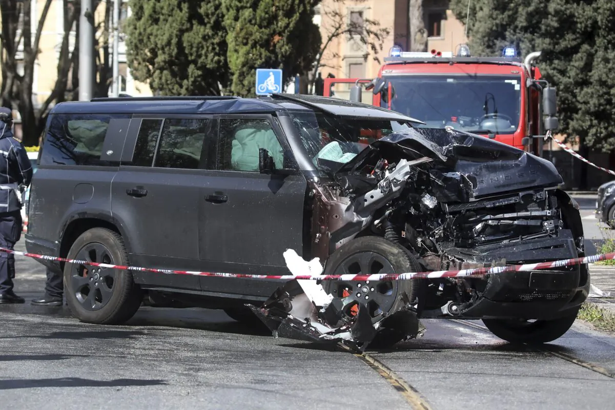 The damaged car of Lazio's soccer player Ciro Immobile lies by the road after crashing, in Rome, on April 16, 2023. (Roberto Monaldo/LaPresse via AP)