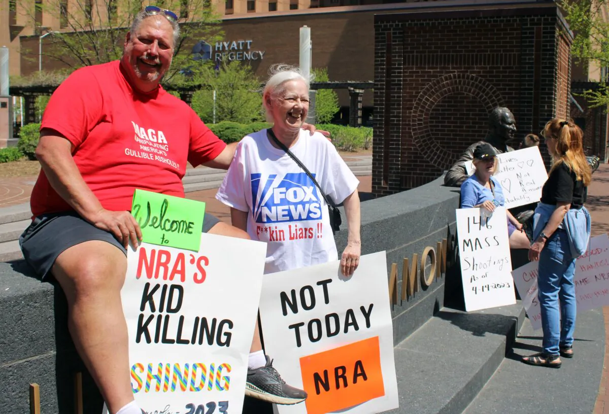 Kerry Worthington (L) was one of a small group of protestors at the National Rifle Association's Annual Meetings and Exhibits in Indianapolis, Ind., on April 15, 2023. (Michael Clements/The Epoch Times)