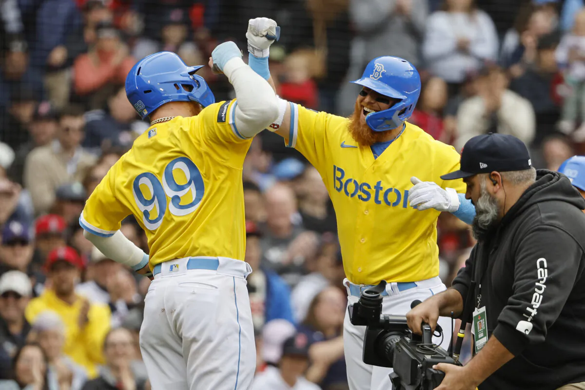 Justin Turner (2) of the Boston Red Sox is congratulated by Alex Verdugo (99) after his two-run home run against the Los Angeles Angels during the third inning at Fenway Park in Boston on April 16, 2023. (Winslow Townson/Getty Images)