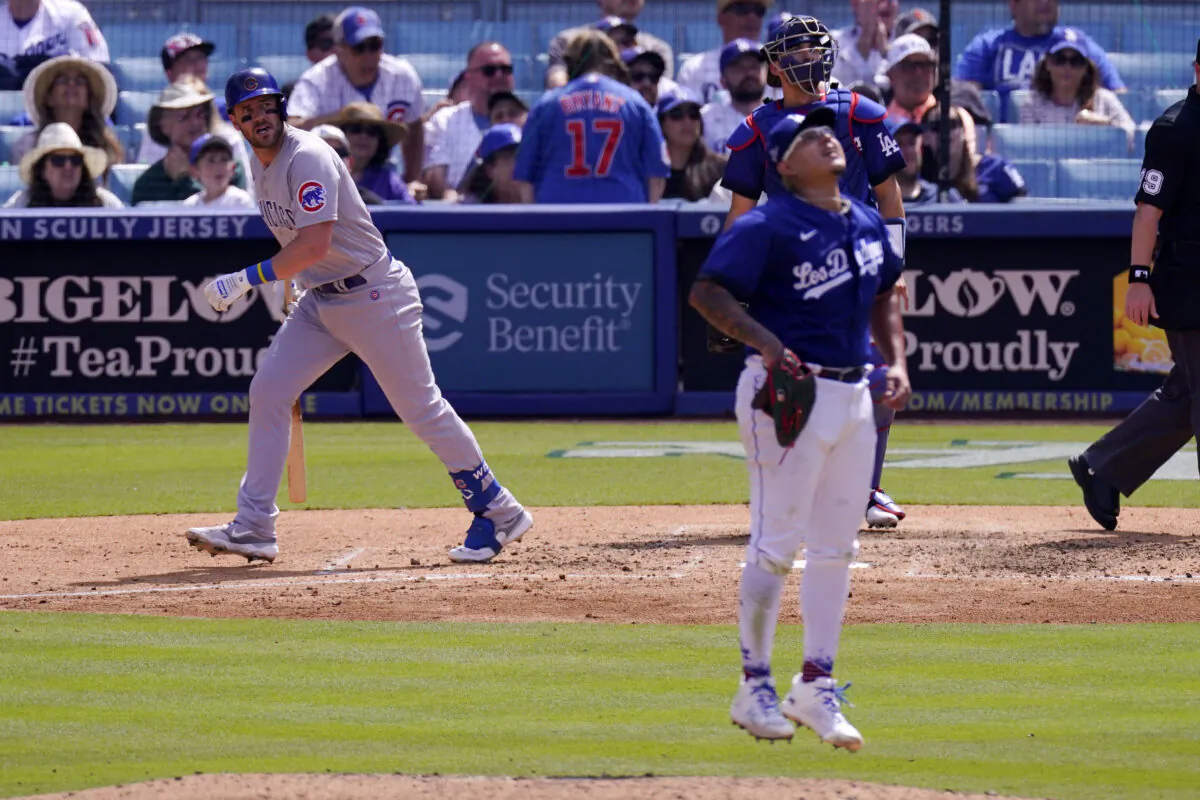Chicago Cubs' Patrick Wisdom, left, heads to first after hitting a solo home run while Los Angeles Dodgers starting pitcher Julio Urias, center, and catcher Austin Barnes watch during the sixth inning of a baseball game in Los Angeles on April 16, 2023,. (Mark J. Terrill/AP Photo)
