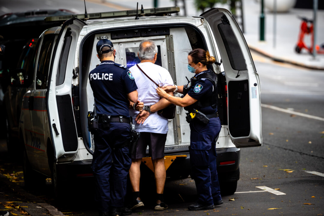 Police arrest a man for resisting to wear a face mask on the first day of a snap lockdown in Brisbane, Australia, on Jan. 9, 2021. (Patrick Hamilton/AFP via Getty Images)