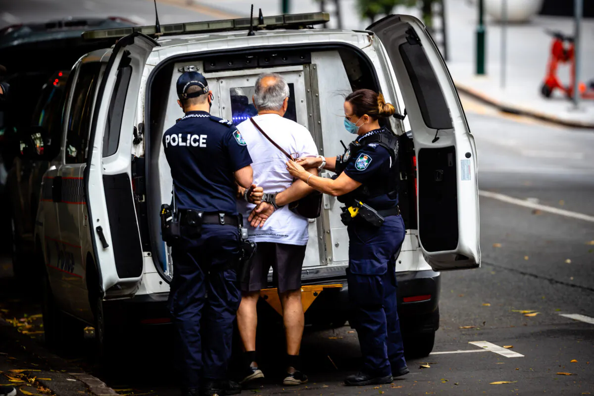 Police arrest a man for resisting to wear a face mask on the first day of a snap lockdown in Brisbane, Australia, on Jan. 9, 2021. (Patrick Hamilton/AFP via Getty Images)