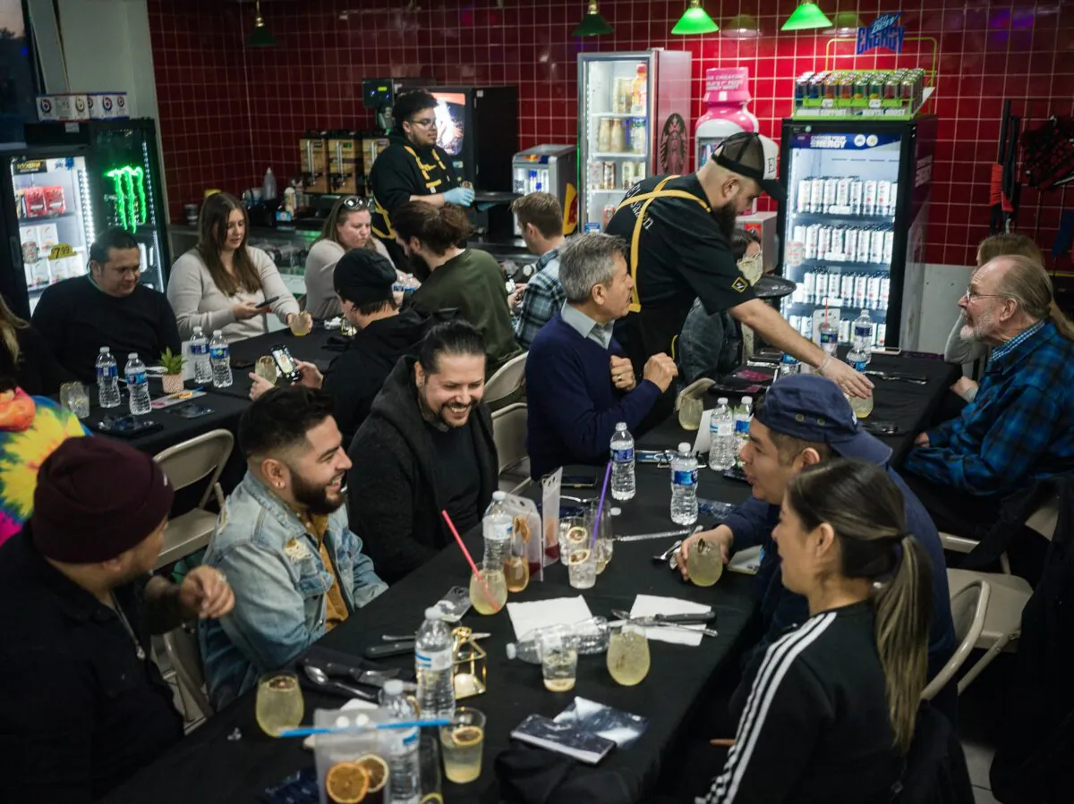 Guests enjoy the festive ambiance inside the gas station in Eagan, Minnesota, on March 26, 2023. A five-course tasting menu in a gas station? Chef Cristian de Leon is serving just that, and more, at El Sazon Tacos & More. His tiny taco shop in a BP in Eagan turns into a fine dining pop-up every few months. (Richard Tsong-Taatarii/Minneapolis Star Tribune/TNS)