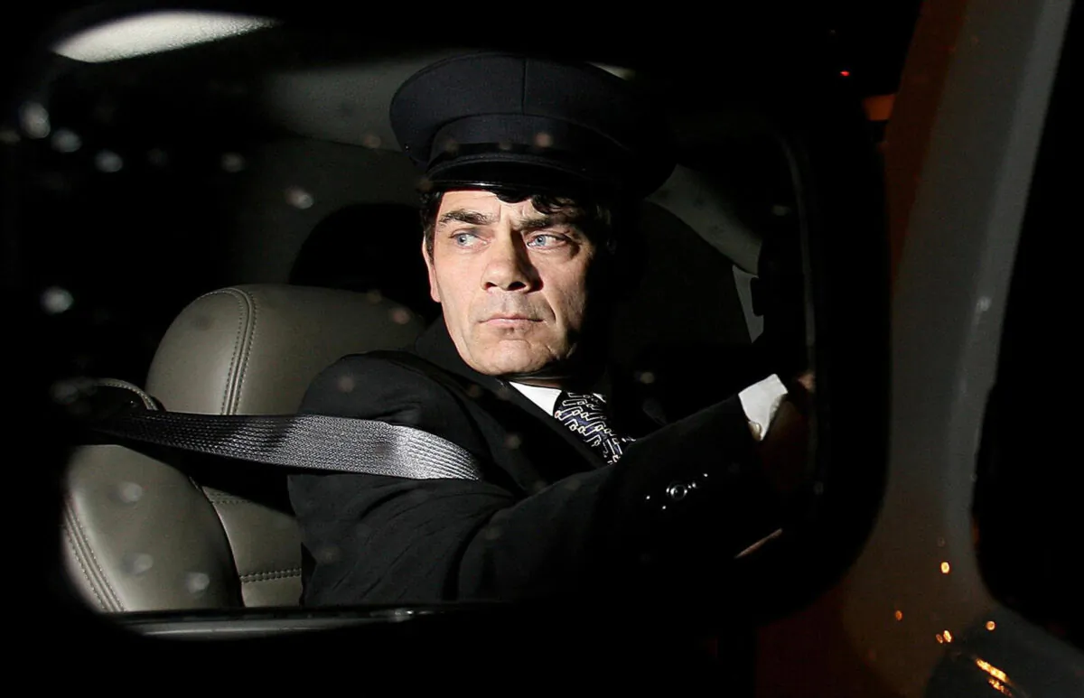 Gerry "The Monk" Hutch, who was accused of a murder at the Regency Hotel in Dublin in 2016, pictured in the wing mirror of a stretch limousine on March 25, 2006. (PA)