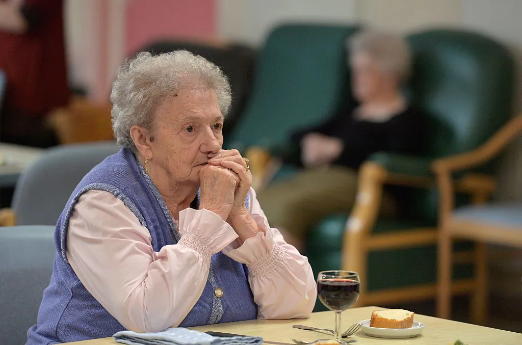 A woman with Alzheimer's disease looks on during lunch in the refectory of a retirement home on Oct. 18, 2016 in Saint Quirin, eastern France. (Photo credit should read PATRICK HERTZOG/AFP via Getty Images)