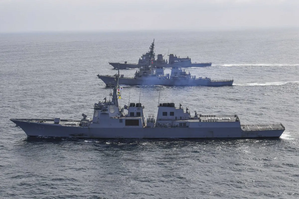 South Korean Navy's destroyer Yulgok Yi I, bottom, U.S. Navy's the guided missile destroyer USS Benfold, and Japan Maritime Self-Defense Force's destroyer Atago, top, sail during a joint missile defense drill among South Korea, the United States, and Japan in the international waters of the east coast of Korean peninsular on April 17, 2023. (South Korea Defense Ministry via AP)