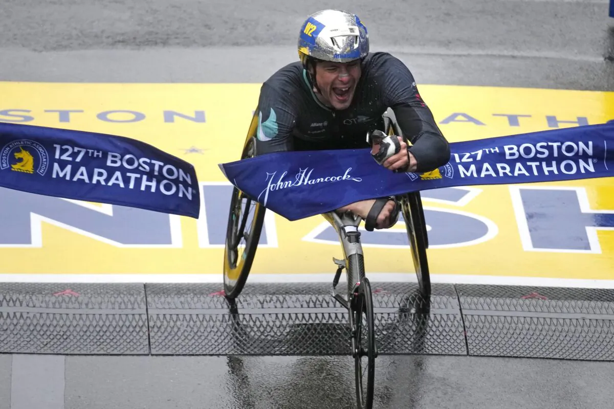 Marcel Hug, of Switzerland, breaks the tape to win the men's wheelchair division of the Boston Marathon in Boston on April 17, 2023. (Charles Krupa/AP Photo)