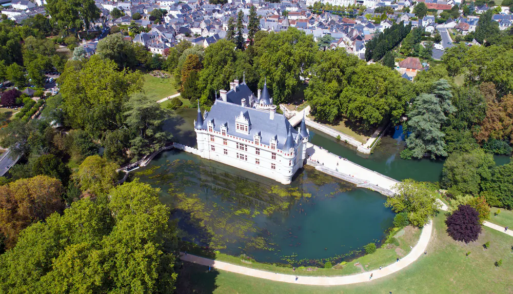 Elegantly set on an island in the river Indre (Loire Valley), the Château of Azay-le-Rideau is considered to be one of the earliest buildings designed in the French Renaissance style. The famous water mirror dates from the 20th century, when the river branch expanded to border the château’s foundation. Ever since then, the château’s glorious façade has been reflected in a water mirror and continues to charm visitors. (Altitude Drone/Shutterstock)