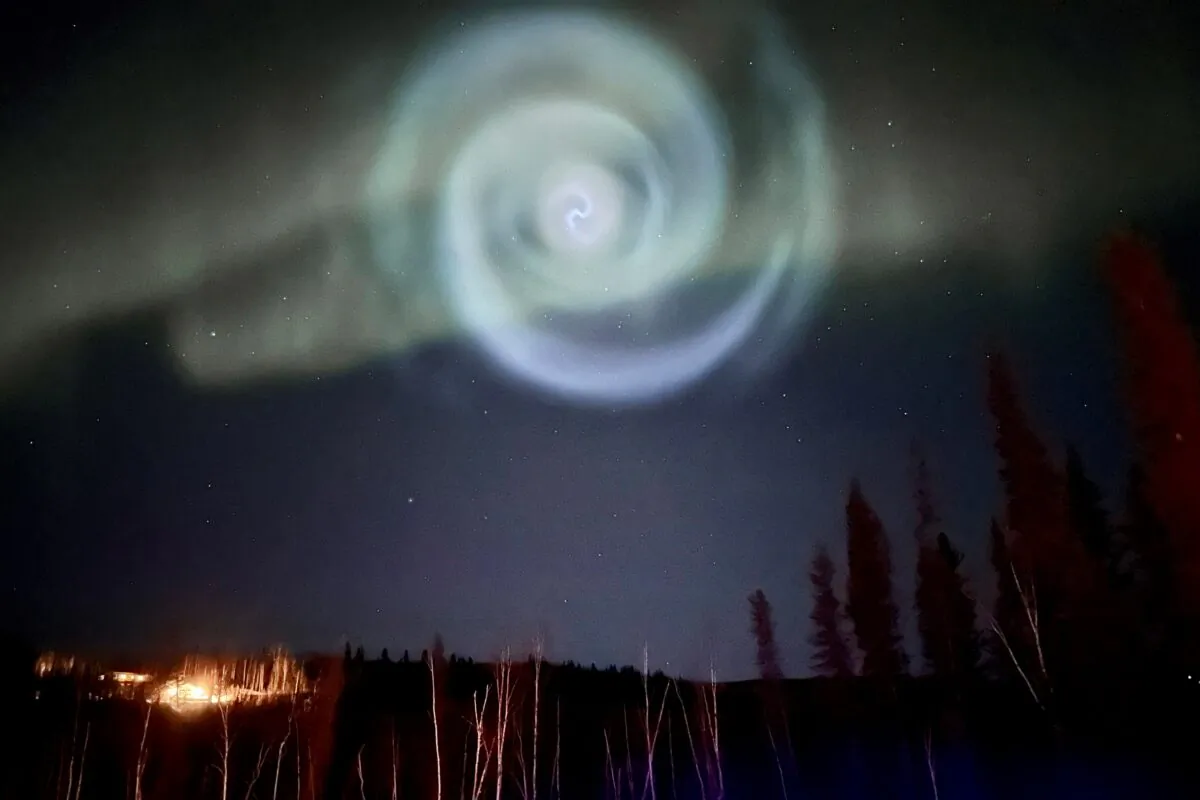 A light baby blue spiral resembling a galaxy appears amid the aurora for a few minutes in the Alaska skies near Fairbanks, on April 15, 2023. (Christopher Hayden via AP)