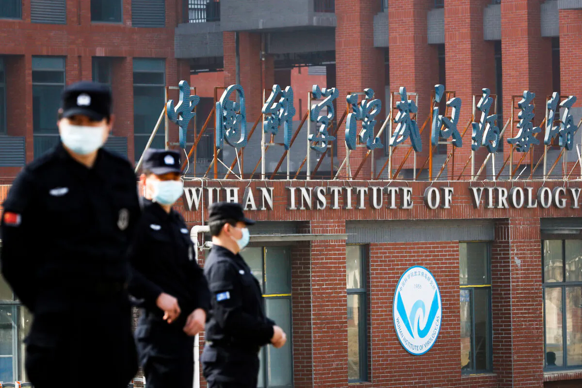 Security personnel keep watch outside the Wuhan Institute of Virology during a visit by the World Health Organization team tasked with investigating the origins of COVID-19, in Wuhan, China, on Feb. 3, 2021. (Thomas Peter/Reuters)