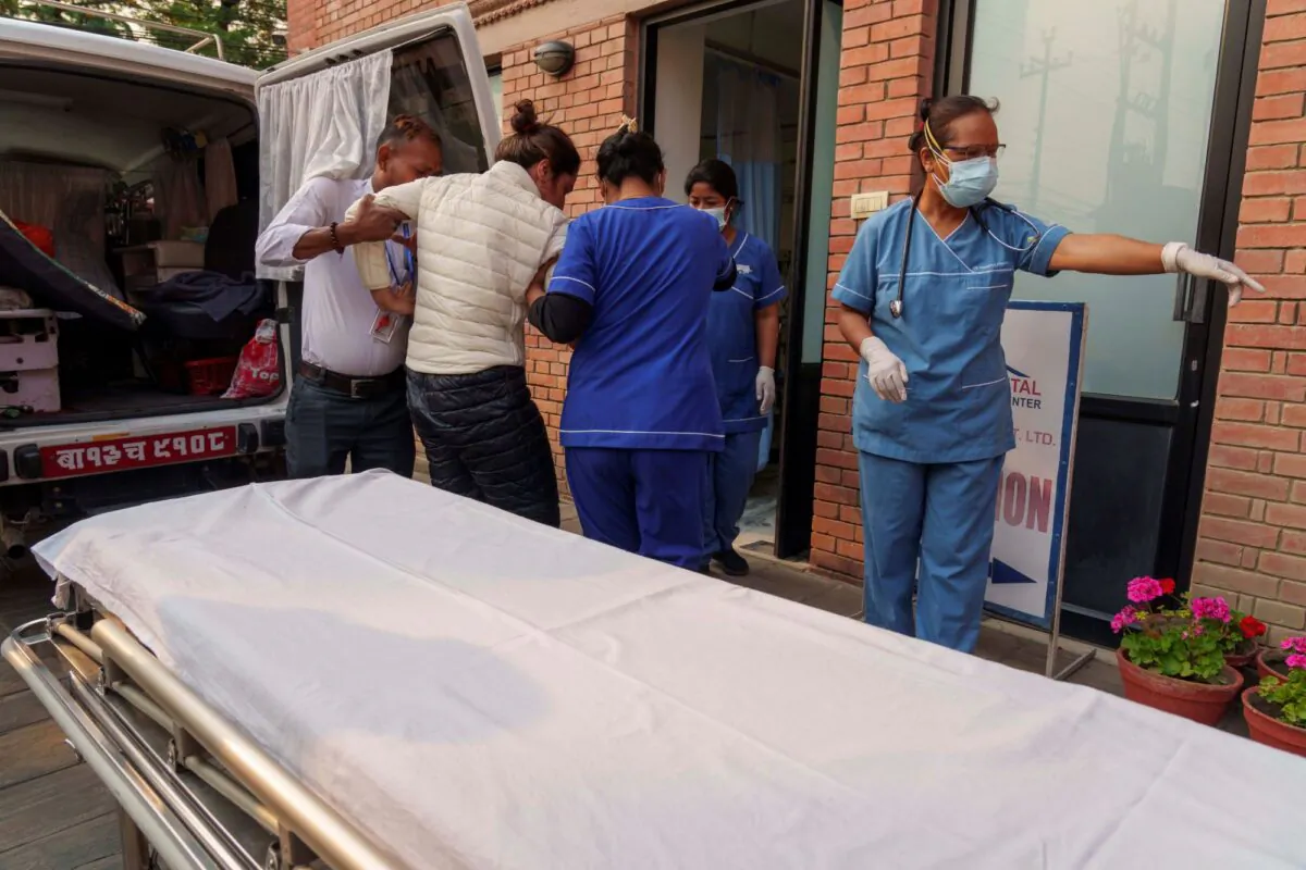 An injured Indian climber who was rescued from the Annapurna mountain region is brought to a hospital in Kathmandu, Nepal, on April 18, 2023. (Niranjan Shrestha/AP Photo)