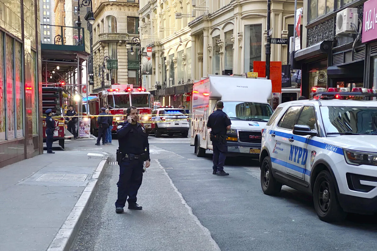 New York City Police and Fire Department personnel cordon off an area in New York's Financial District on April 18, 2023, near the site of a partially collapsed parking garage. (Julie Jacobson/AP Photo)