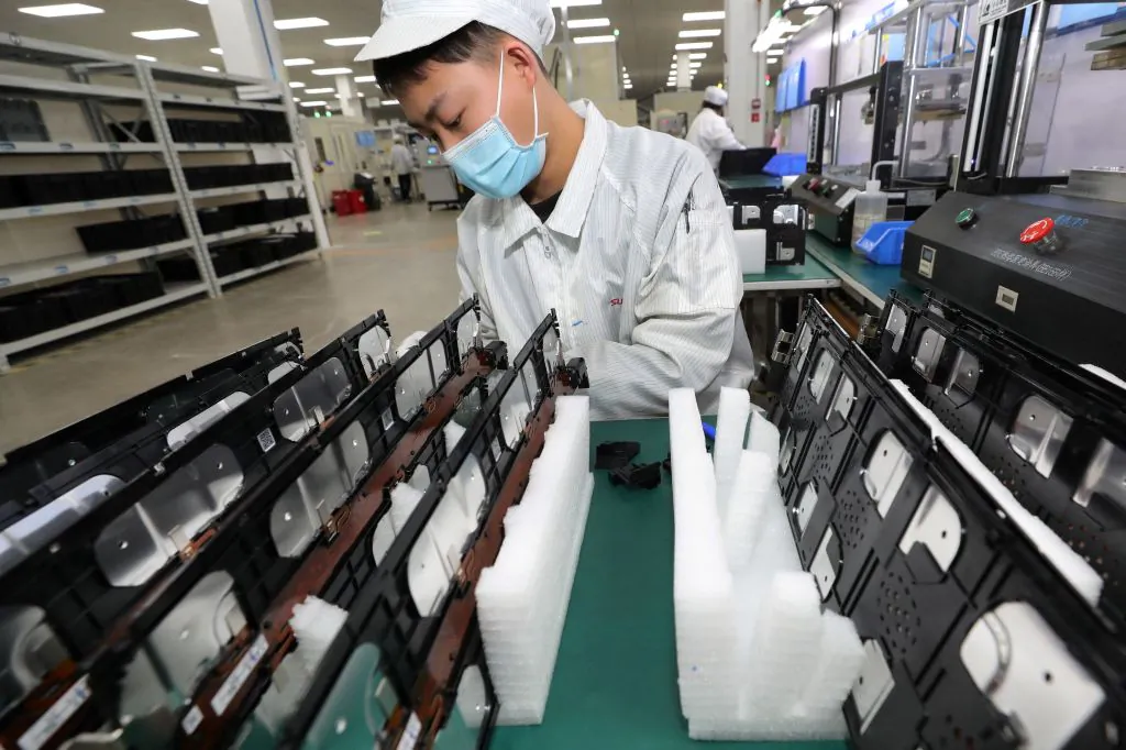 A worker at a factory for Xinwangda Electric Vehicle Battery Co. Ltd, which makes lithium batteries for electric cars and other uses, in Nanjing in China's eastern Jiangsu province on March 12, 2021. (STR/AFP via Getty Images)
