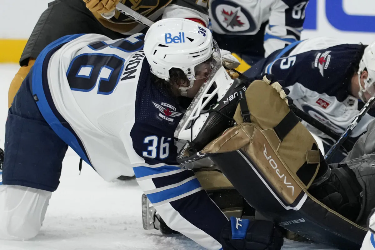Winnipeg Jets center Morgan Barron (36) gets his face cut on the skate of Vegas Golden Knights goaltender Laurent Brossoit (39) during the first period of Game 1 of an NHL hockey Stanley Cup first-round playoff series in Las Vegas on April 18, 2023. (John Locher/AP Photo)