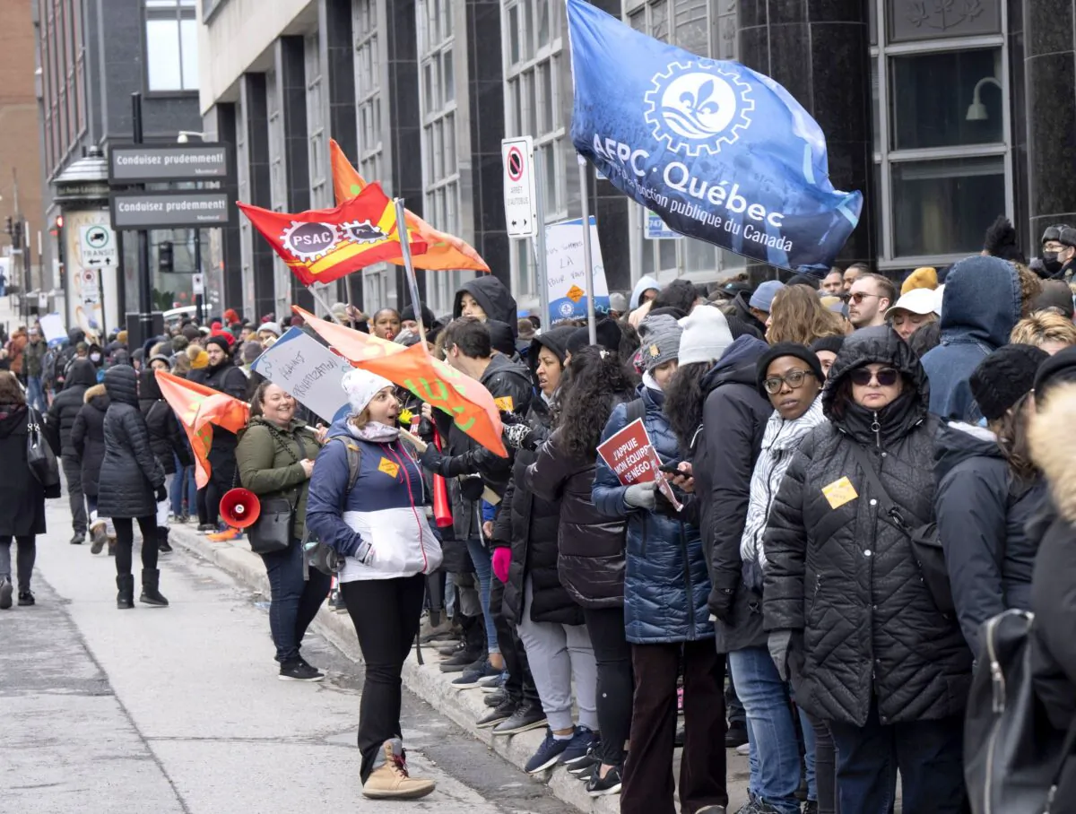 Canada Revenue Agency workers form a picket line as over 150,000 Public Service Alliance of Canada federal employees go on strike across the country, in Montreal on April 19, 2023. (The Canadian Press/Ryan Remiorz)
