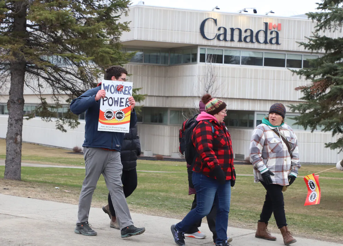 PSAC workers and supporters picket outside the Canada Revenue Agency office in Sudbury, Ont., on April 19, 2023. (Gino Donato/The Canadian Press)