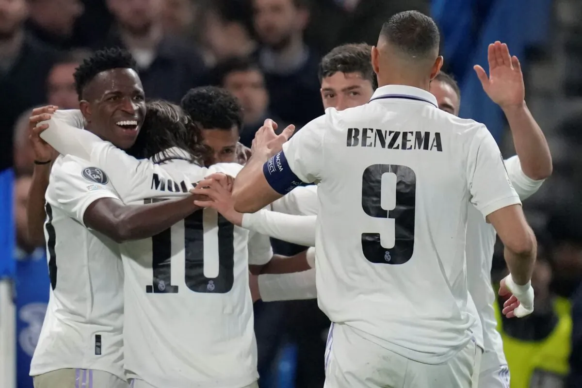 Real Madrid's players celebrates after Rodrygo scored the opening goal during the Champions League quarterfinal second leg soccer match between Chelsea and Real Madrid at Stamford Bridge stadium in London on April 18, 2023. (Kirsty Wigglesworth/AP Photo)