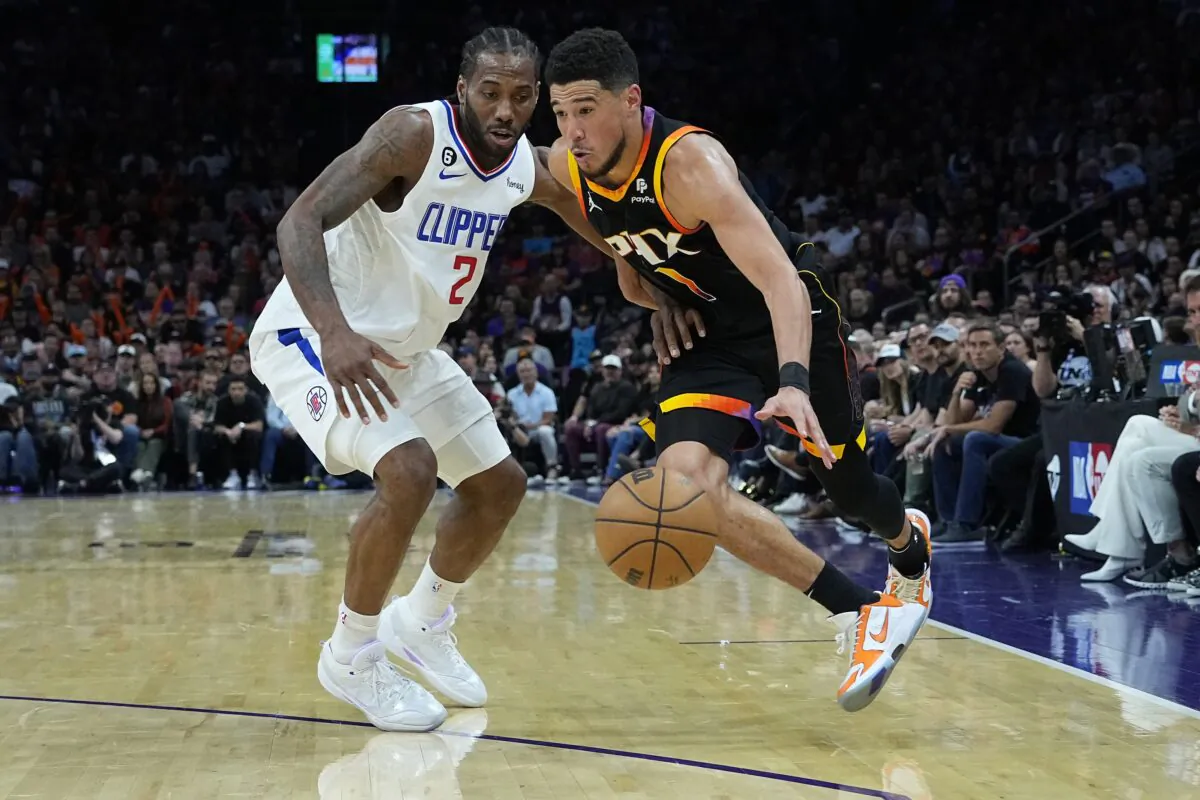 Phoenix Suns guard Devin Booker (1) drives on Los Angeles Clippers forward Kawhi Leonard (2) during the second half of Game 2 of a first-round NBA basketball playoff series in Phoenix on April 18, 2023. (Matt York/AP Photo)