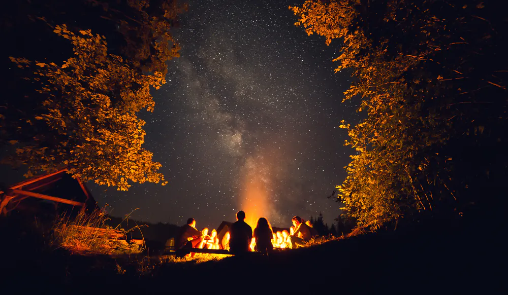 Nights spent with friends around a campfire, singing and roasting marshmallows, are the stuff great memories are made of. (Volodya Senkiv/Shutterstock)