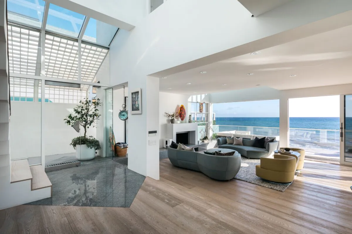 The very airy living room's glass walls provide an ideal place for the owners and guests to gather and mingle as they enjoy an unobstructed view of the beach and the ocean. (Courtesy of Stirling Reed and toptenrealestatedals.com)