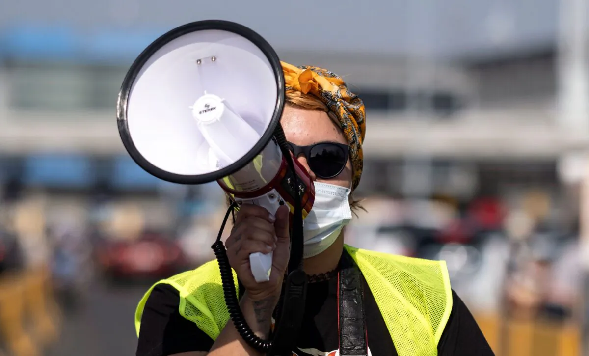 A woman uses a megaphone during a protest in a file photo. (Guillermo Arias/AFP via Getty Images)