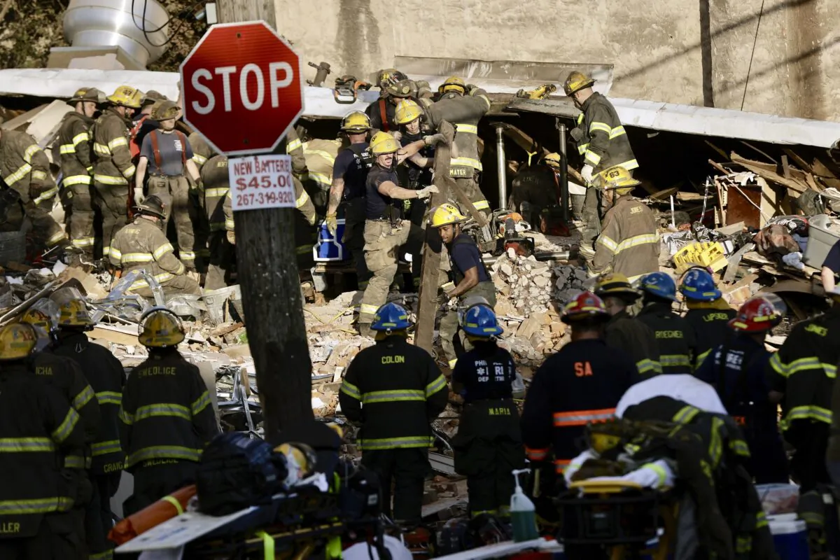 Philadelphia firefighters work to rescue colleagues trapped in a row house collapse on the 300 block of West Indiana on June 18, 2022. (Elizabeth Robertson/The Philadelphia Inquirer via AP)