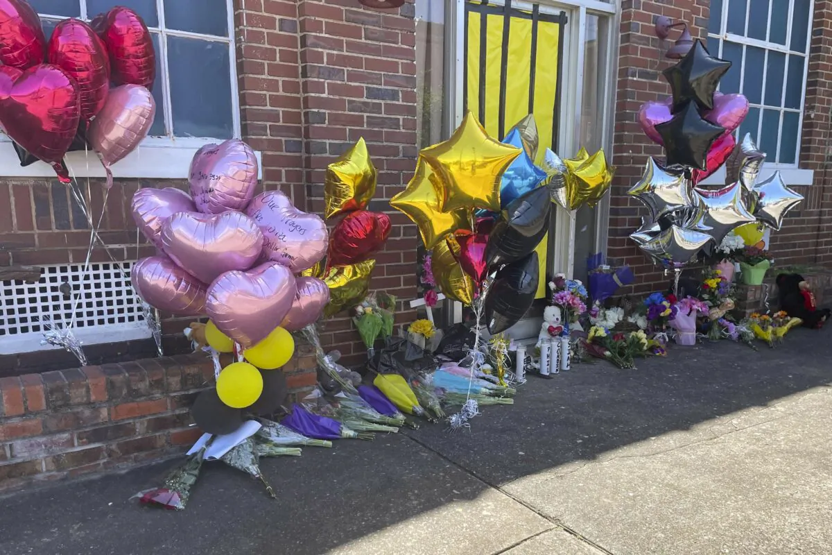 Flowers and balloons sit piled outside the Mahogany Masterpiece dance studio in Dadeville, Ala., on April 19, 2023. (Kimberly Chandler/AP Photo)