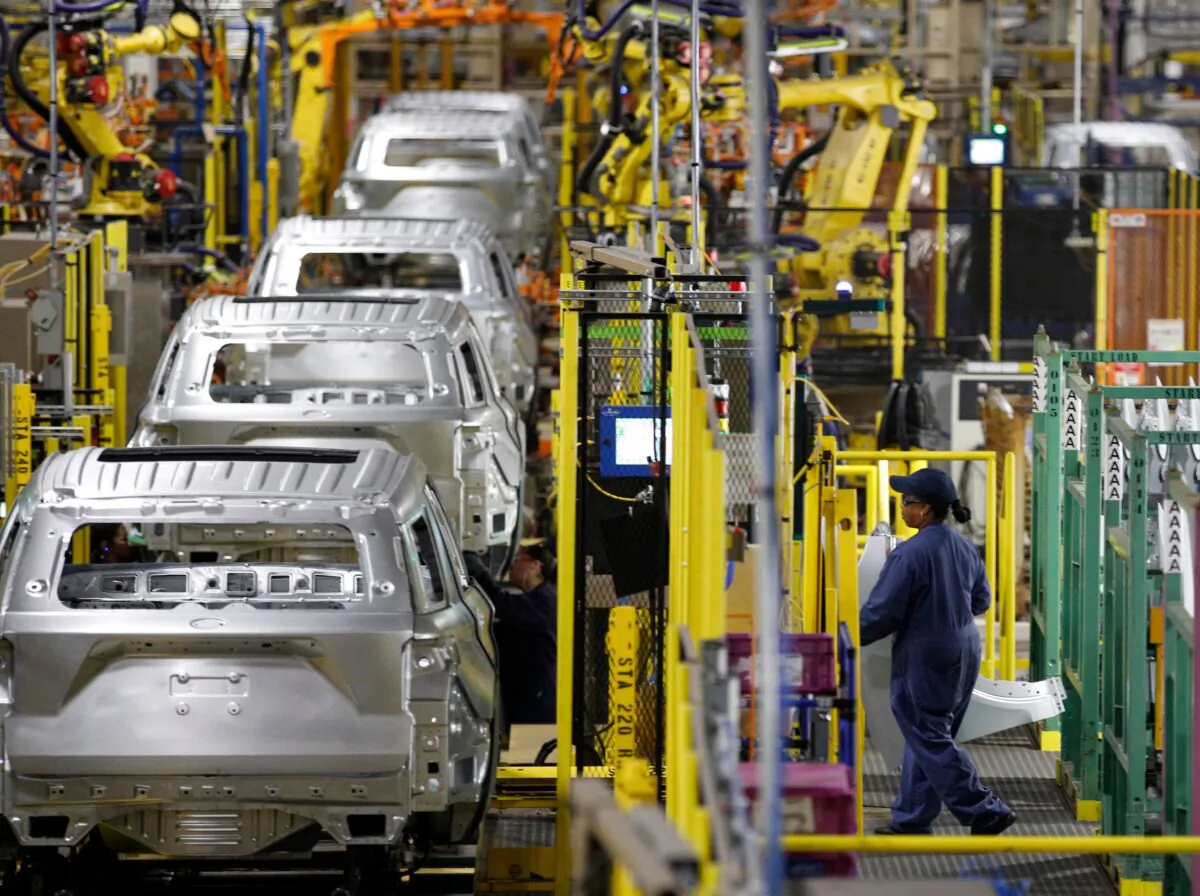 Workers assemble cars at the newly renovated Ford's Assembly Plant in Chicago on June 24, 2019. (Jim Young/AFP via Getty Images)