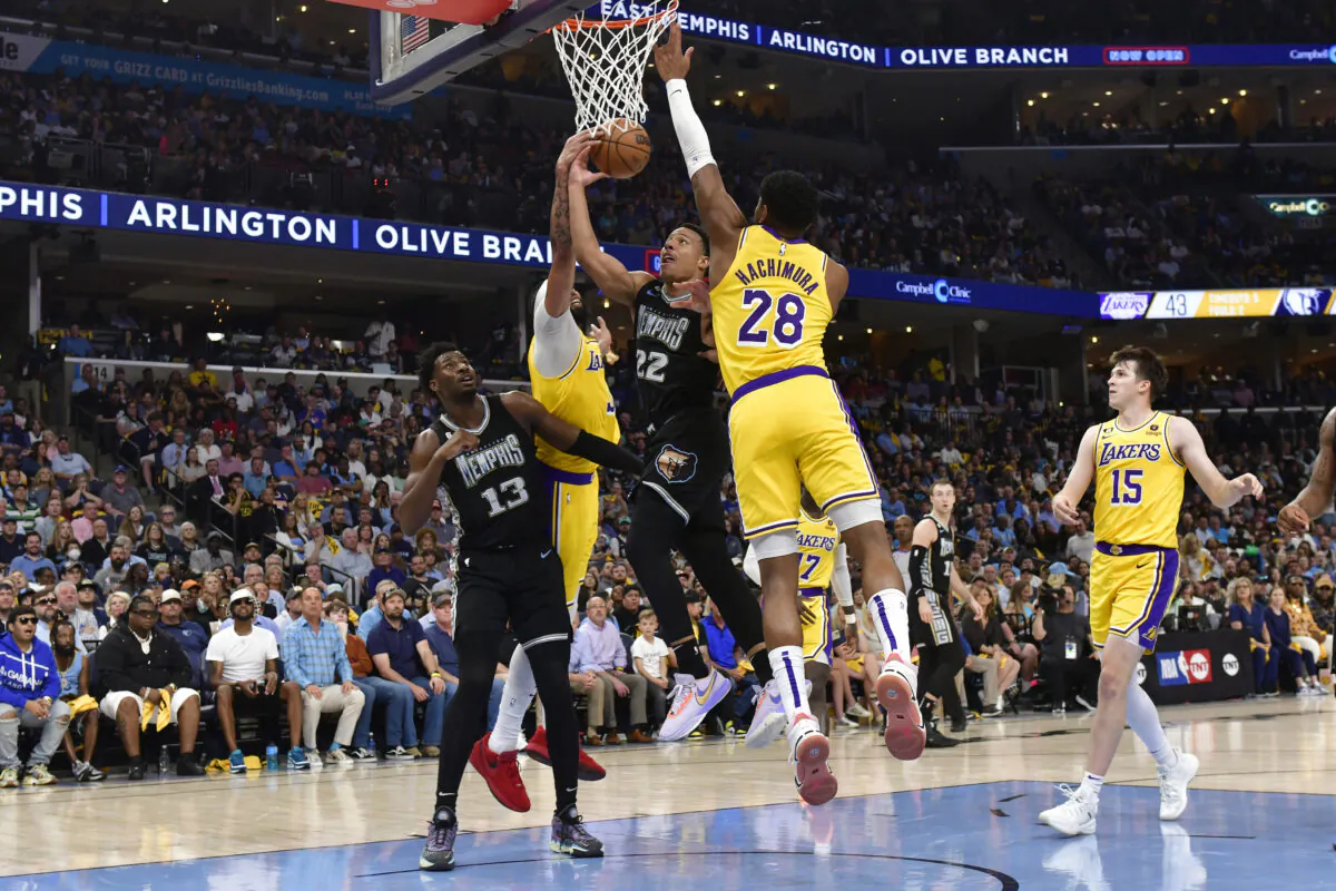 Memphis Grizzlies guard Desmond Bane (22) shoots between Los Angeles Lakers forwards Anthony Davis and Rui Hachimura (28) as Grizzlies forward Jaren Jackson Jr. (13) moves for position during the first half of Game 2 in a first-round NBA basketball playoff series in Memphis on April 19, 2023. (Brandon Dill/AP Photo)
