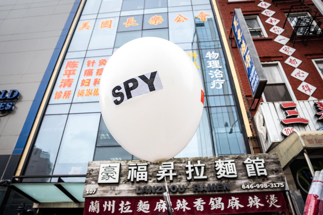 A balloon is held at a press conference and rally in front of the America ChangLe Association highlighting Beijing's transnational repression in New York City on Feb. 25, 2023. A now-closed overseas Chinese police station is located inside the association building.(Samira Bouaou/The Epoch Times)