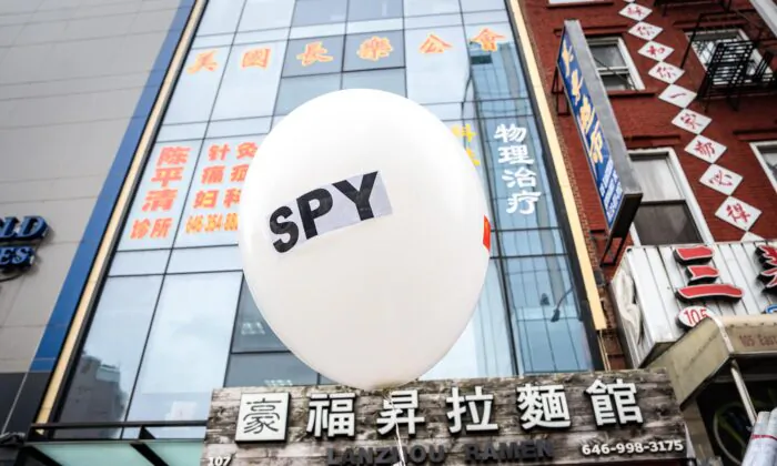 A balloon is held at a press conference and rally in front of the America ChangLe Association highlighting Beijing's transnational repression, in New York City on Feb. 25, 2023. A now-closed overseas Chinese police station is located inside the association building.(Samira Bouaou/The Epoch Times)