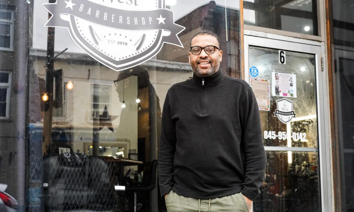 Freddie Williams in front of his barbershop on Main Street in Middletown, N.Y., on Apr. 19, 2023. (Cara Ding/The Epoch Times)