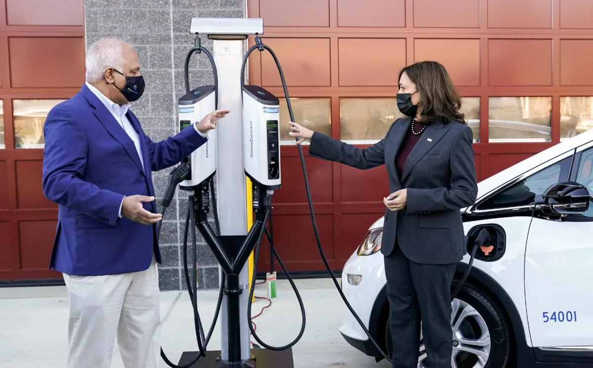 FILE PHOTO: U.S. Vice President Kamala Harris speaks with SemaConnect CEO Mahi Reddy at the Prince George's County Brandywine Maintenance Facility during a visit to announce the Biden-Harris Administration’s Electric Vehicle Charging Action Plan, in Brandywine, Maryland, U.S., December 13, 2021. REUTERS/Kevin Lamarque