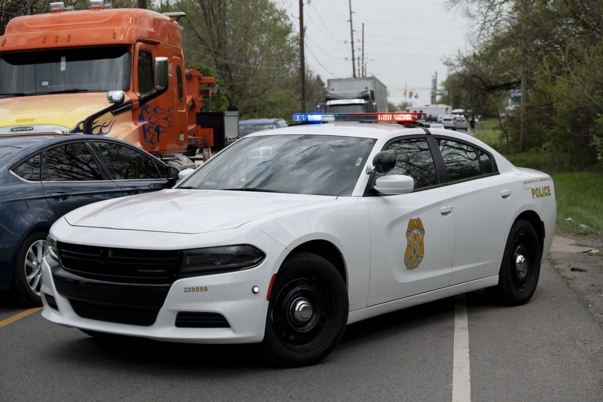Law enforcement personnel and emergency responders gather at the intersection of East 30th Street and Franklin Road as they work the scene of a nearby shooting in Indianapolis on April 20, 2023. (Mykal McEldowney/The Indianapolis Star via AP)
