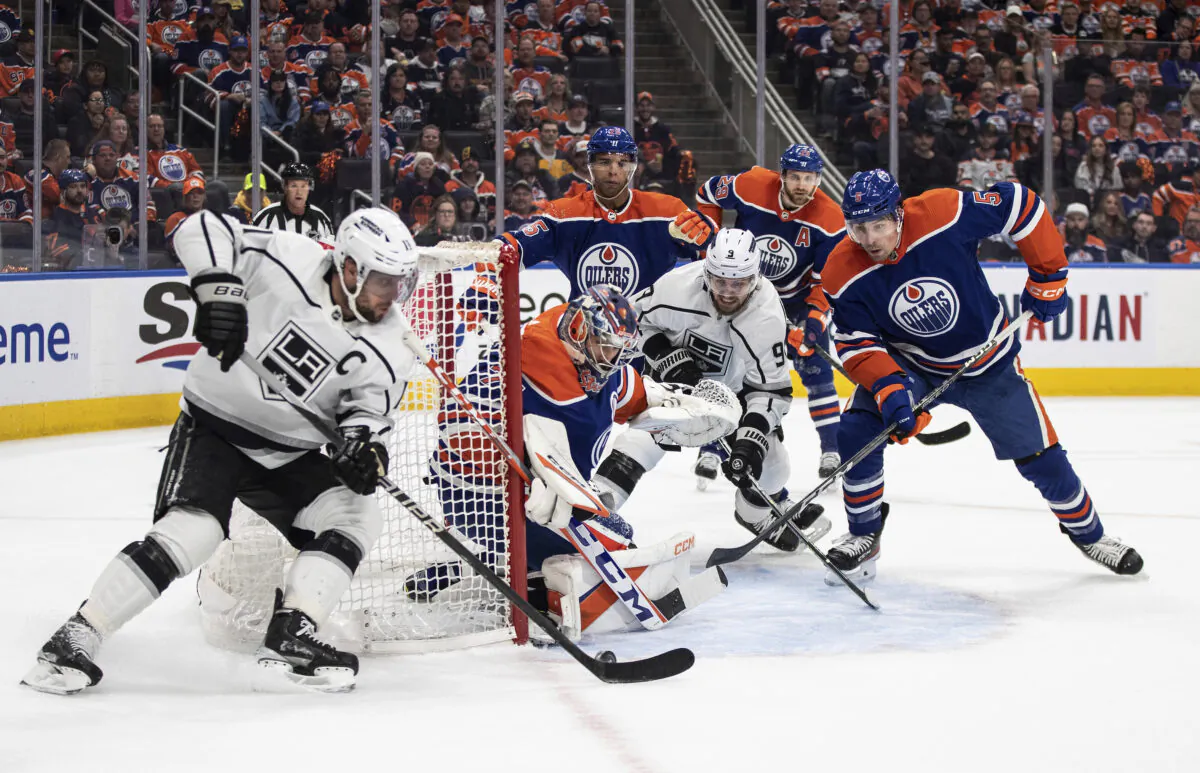 Los Angeles Kings' Anze Kopitar, left, is stopped by Edmonton Oilers goalie Stuart Skinner (74) during the first period of Game 2 of an NHL hockey Stanley Cup first-round playoff series in Edmonton, Alberta, on April 19, 2023. (Jason Franson/The Canadian Press via AP)