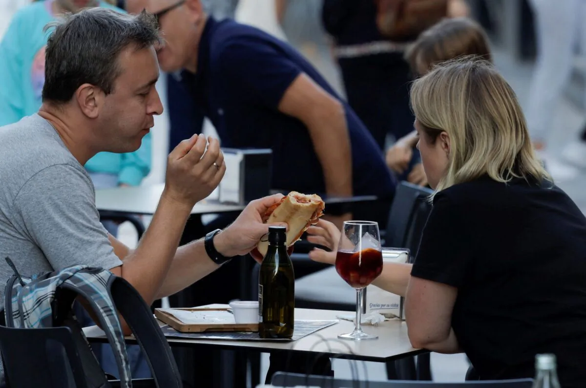 Tourists have a snack on the terrace of a restaurant in Ronda, Spain, on Oct. 13, 2022. (Jon Nazca/Reuters)