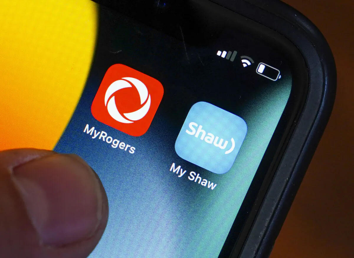Rogers and Shaw applications are pictured on a cellphone in Ottawa on May 9, 2022. (Sean Kilpatrick/The Canadian Press)