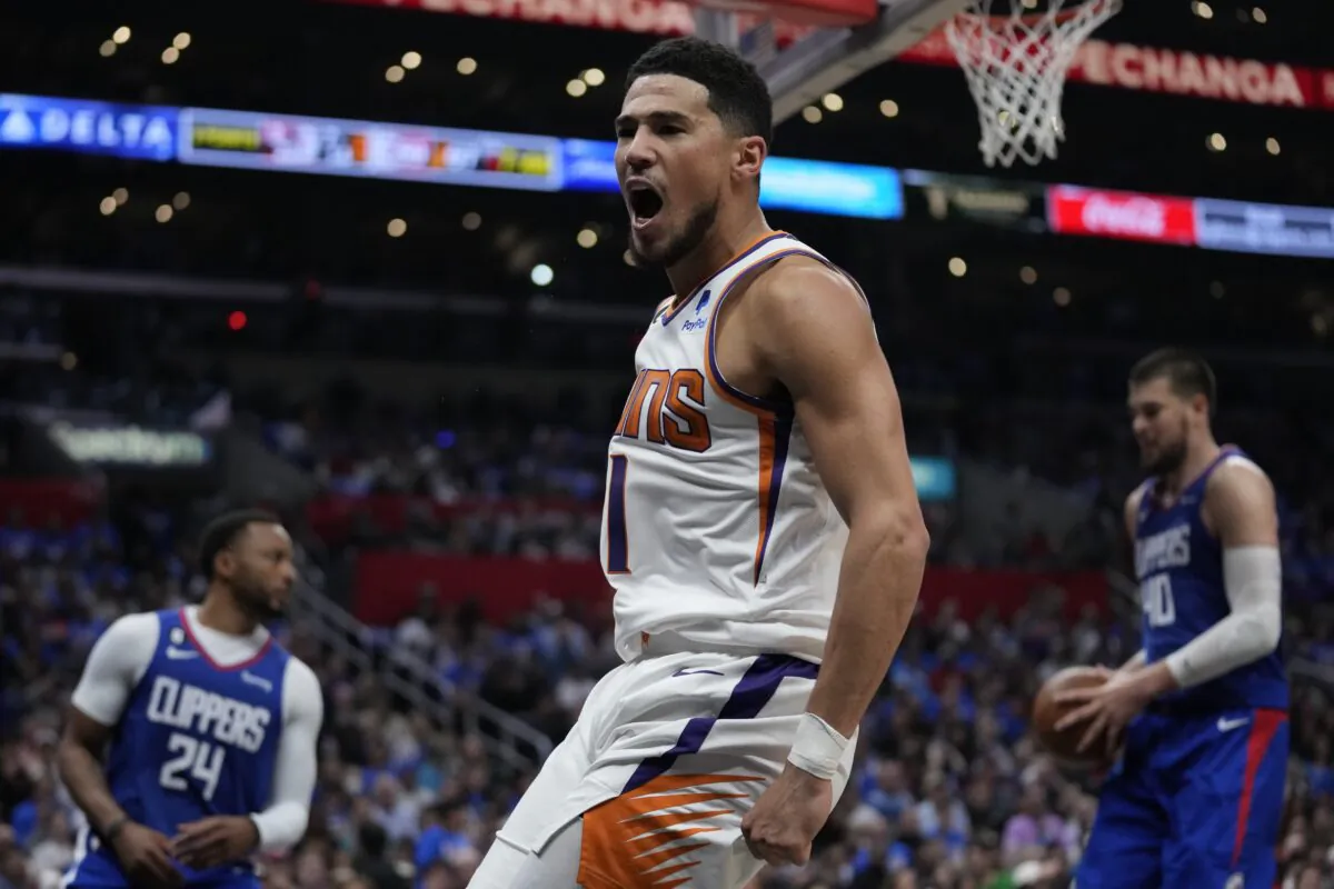 Phoenix Suns guard Devin Booker (1) reacts after dunking the ball during the second half of Game 3 of a first-round NBA basketball playoff series against the Los Angeles Clippers in Los Angeles on April 20, 2023. (Ashley Landis/AP Photo)